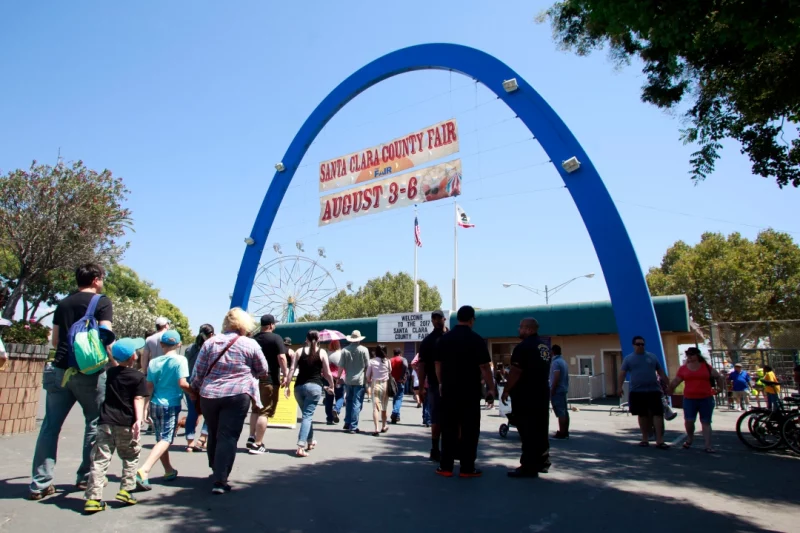 Attendees to the Santa Clara County Fair file in under the blue arch for the final day, Sunday, Aug. 6, 2017, in San Jose, California.